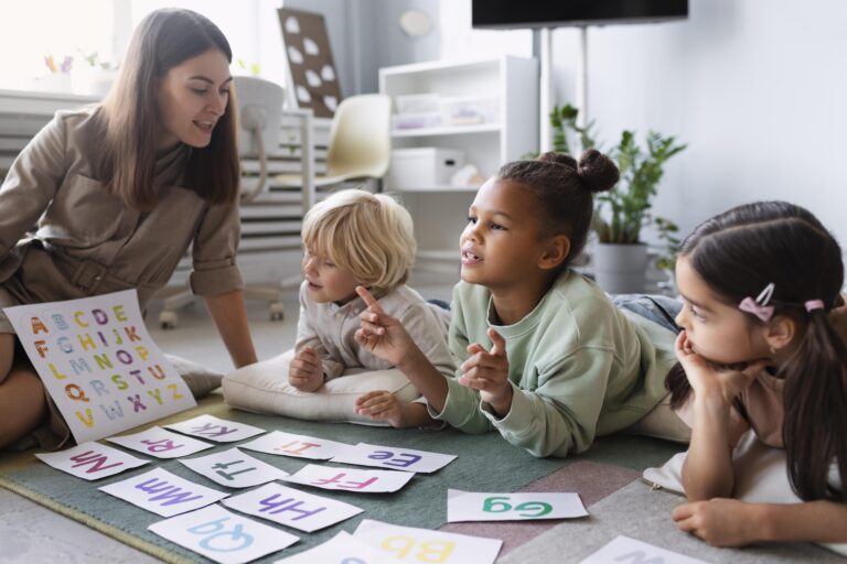 literacy teacher working with young readers on phonics reading lesson