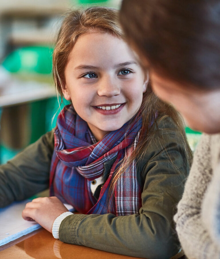 Happy middle school girl with her reading tutor