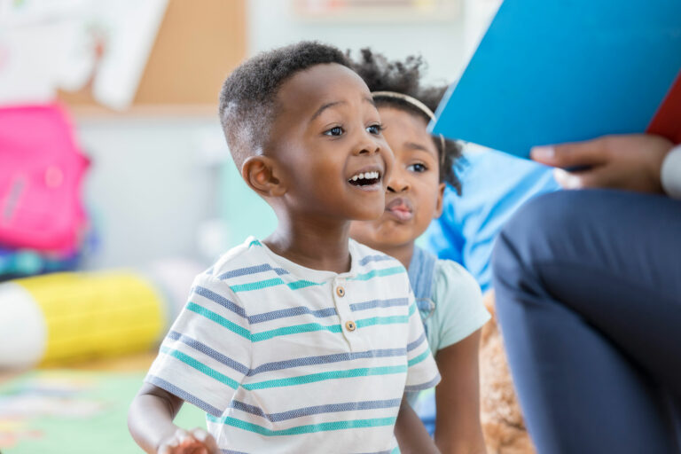 An elementary school boy sounds out a word in a literacy classroom