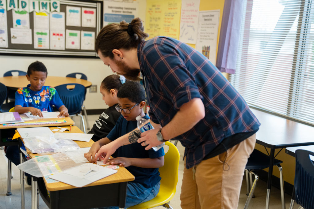 A reading specialist engages a student in tactile phonics materials