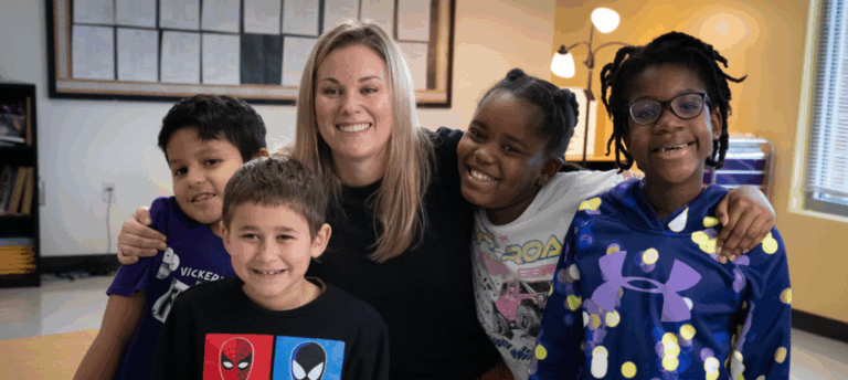 Happy teacher and joyful students in a group photo