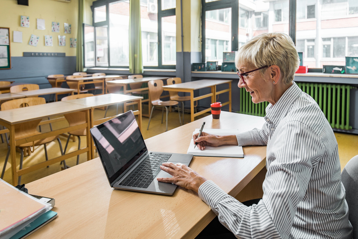 Literacy teacher enjoying a webinar on her laptop at a convenient time