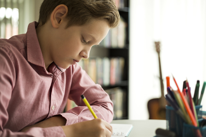 Middle school boy absorbed in his phonics lesson