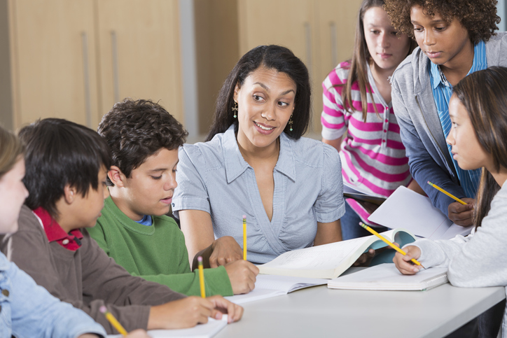 Teacher leads her middle school students in a science of reading-backed workbook exercise