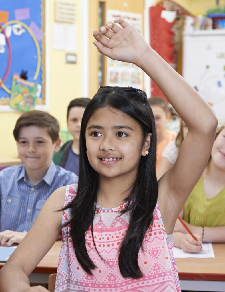 Middle school student with raised hand