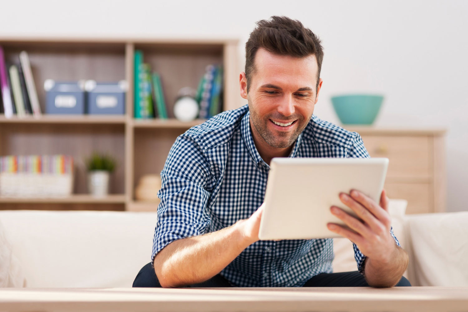 A teacher holds his tablet, completing his professional learning course at his convenience