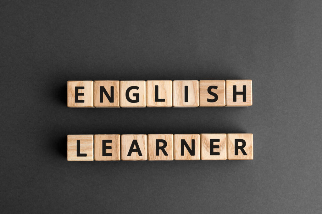 An English learner is spelled out in letter blocks