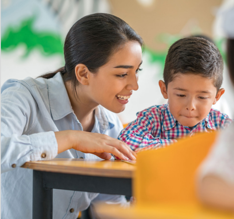 Teacher and student reading together