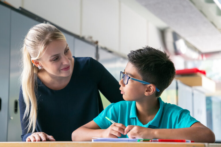 teacher helping student with dyslexia to read