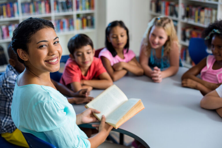 teacher reading to elementary students