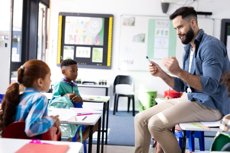 elementary school teacher speaking with students