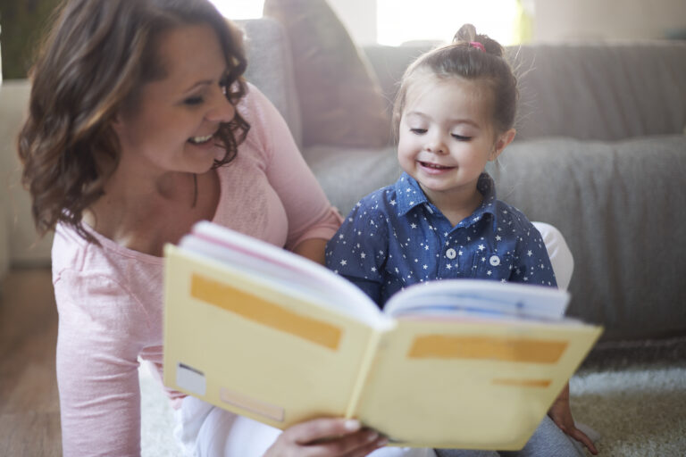 mother reading book with young child