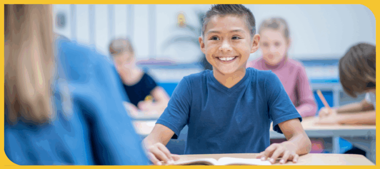 young boy student smiling and listening to teacher with open book