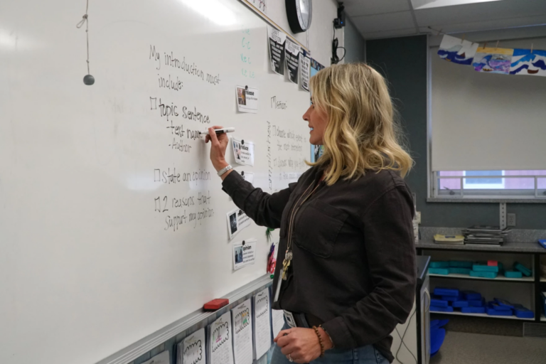 Park City Schools educator writing on whiteboard