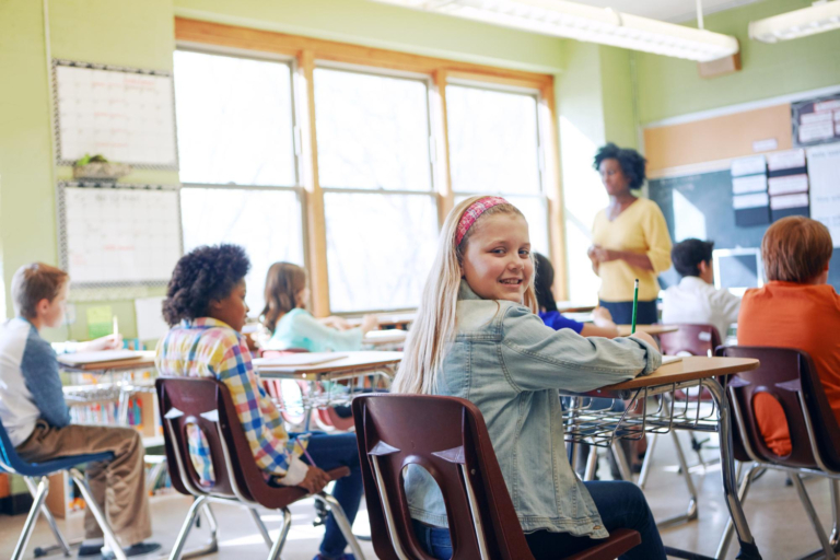 young girl participating in class literacy lesson